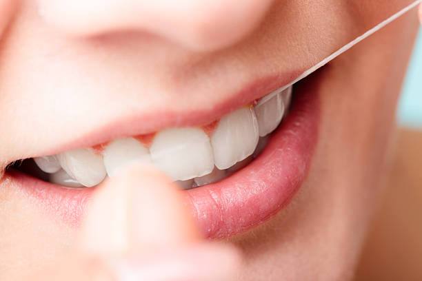 istock Woman smiling with dental floss. 637577796