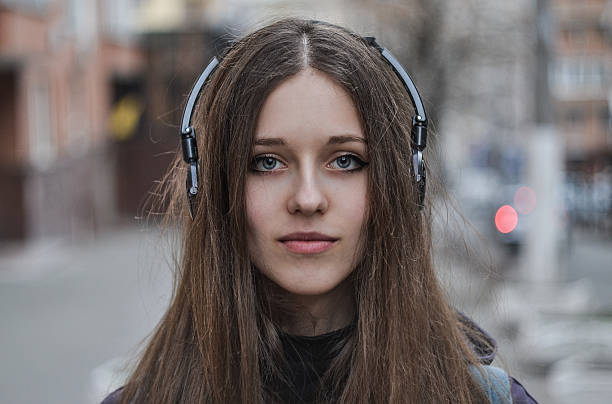 Girl hipster in headphones looking at camera stock photo