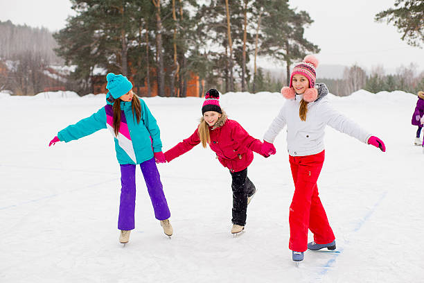 istock three attractive skater girl on the ice 637580068