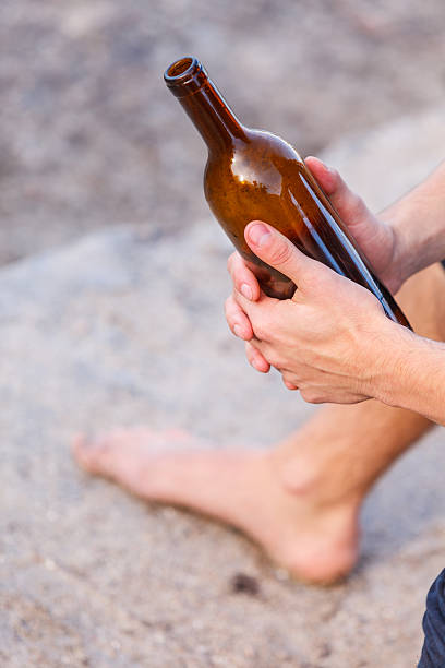 istock Male hand with wine bottle outdoor 637582460