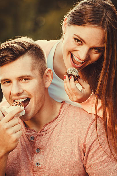istock Lovely couple eating cupcakes. 637582694
