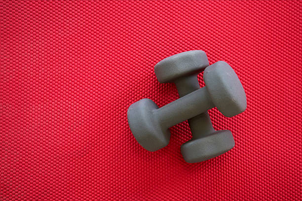 istock Gym equipment on red mat background, top view 637582776