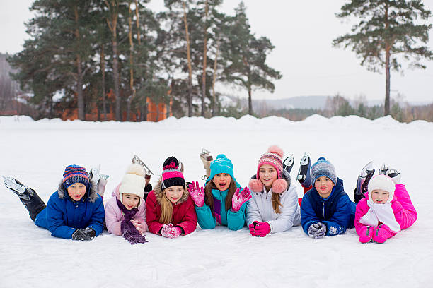 istock group of kids lying on the ice 637583916