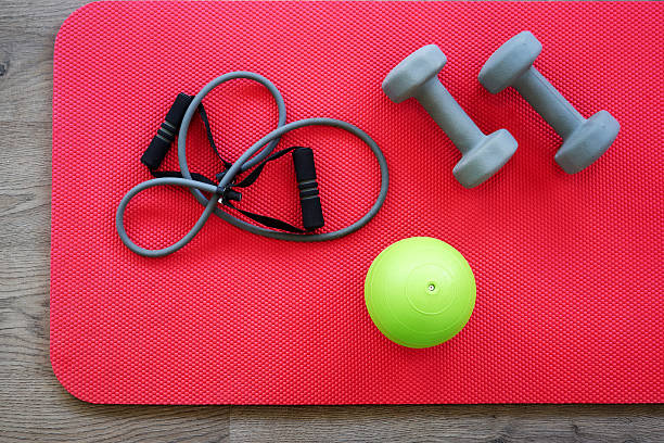 istock Gym equipment on red mat background, top view 637583958