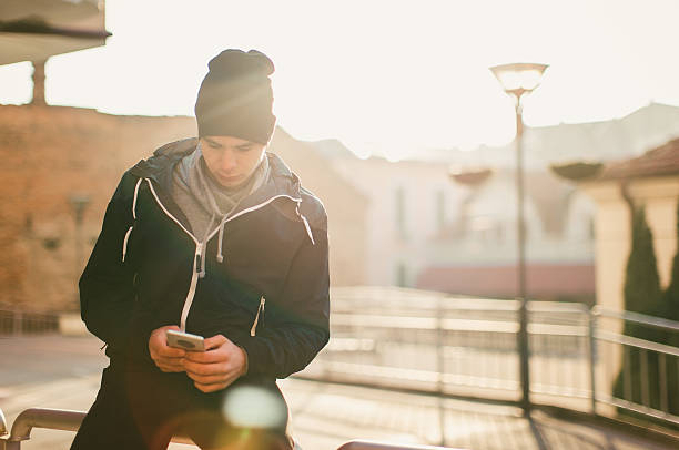 istock Young casual man using smartphone in the urban environment 637585028