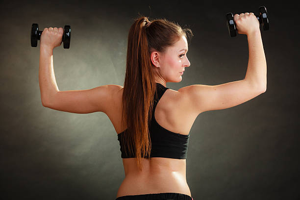 istock Fit woman exercising with dumbbells. 637585544