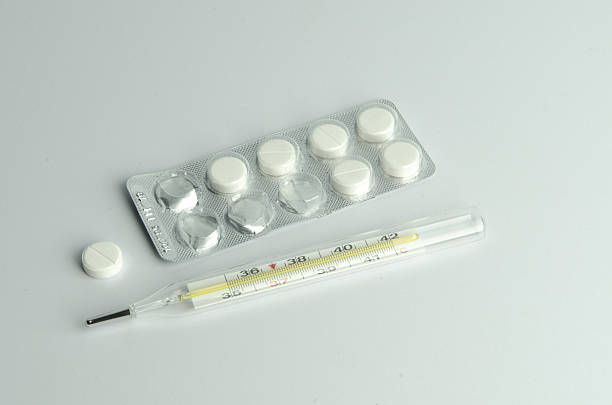 istock Medical thermometer and pills 637590590