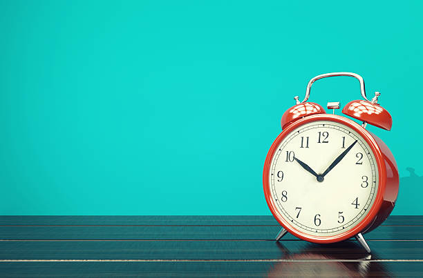 istock Red retro alarm clock on blue background with space 637590646