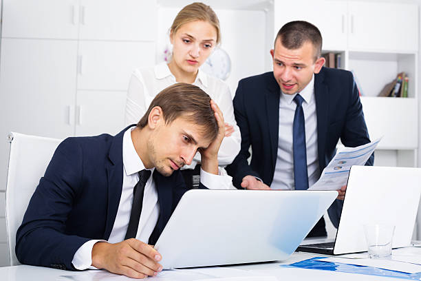 istock three annoyed coworkers in firm office 637593576