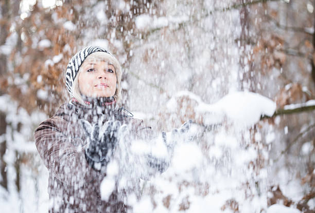 istock Girl tosses snow up. 637595952