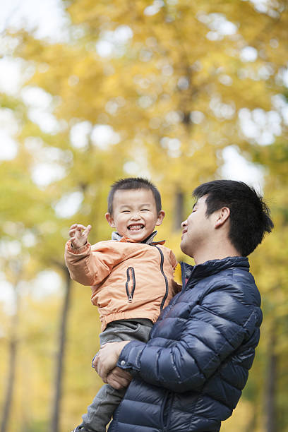 istock Happy real father and son in front of ginkgo trees 637596010
