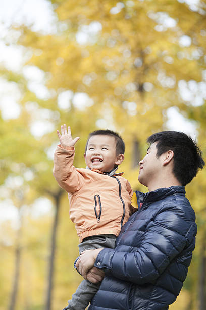 istock Happy real father and son in front of ginkgo trees 637596110