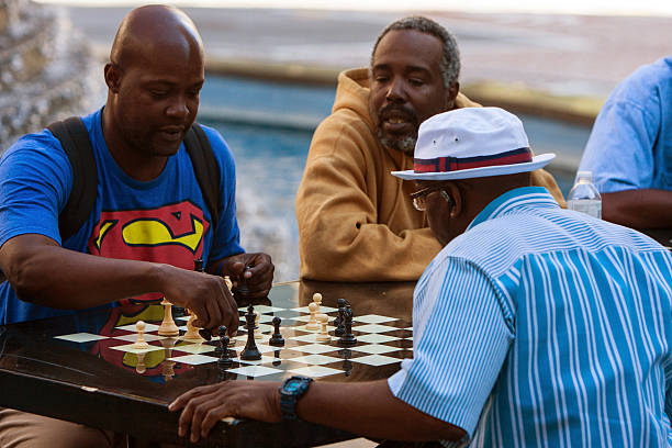 Atlanta, GA, USA - October 8, 2016:  African-American men play chess on a community chess table at Woodruff Park in downtown Atlanta on October 8, 2016 in Atlanta, GA.