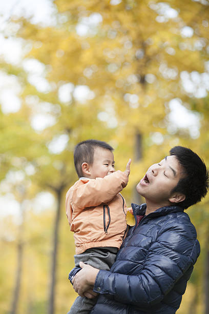 istock Happy real father and son in front of ginkgo trees 637596242
