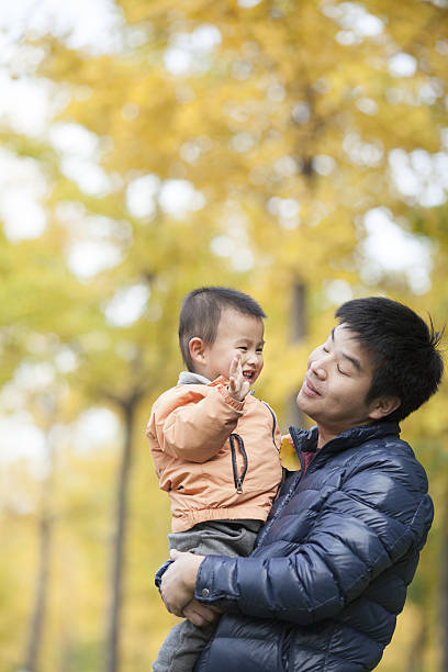istock Happy real father and son in front of ginkgo trees 637596320