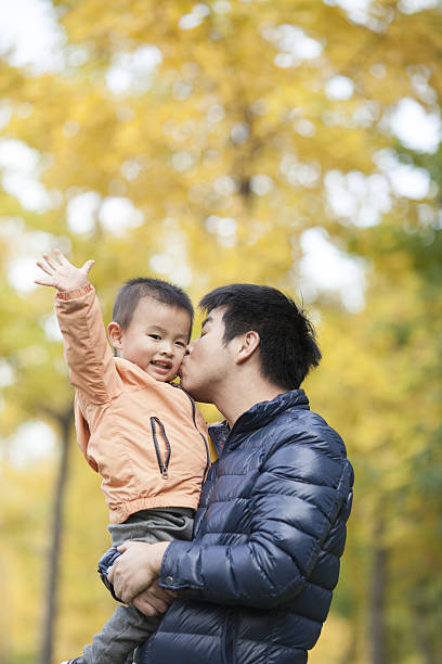 istock Happy real father and son in front of ginkgo trees 637596452