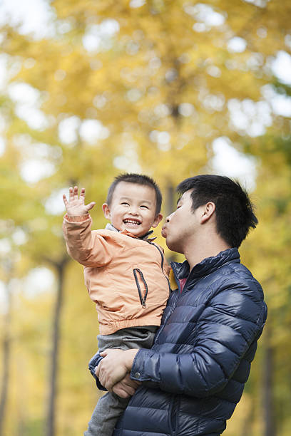 istock Happy real father and son in front of ginkgo trees 637596502