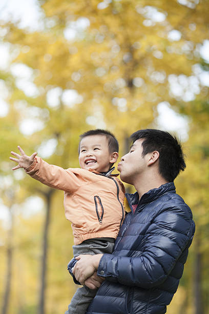 istock Happy real father and son in front of ginkgo trees 637596546