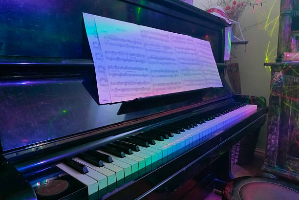 istock Old piano with colorful lights. Classical and modern music conce 637596552
