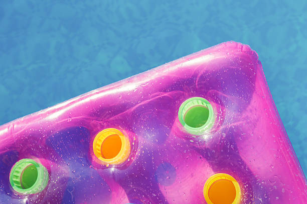 istock Pink air mattress in swimming pool 637597124