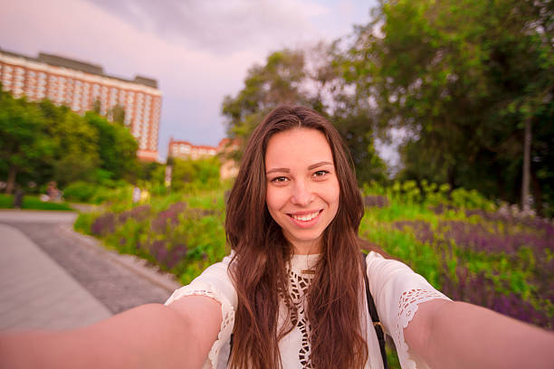 istock Young caucasian woman making selfie on attractions background outdoors. Happy 637599504