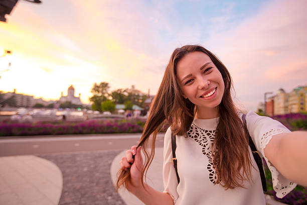 istock Young girl making selfie and having fun in the park. 637599612