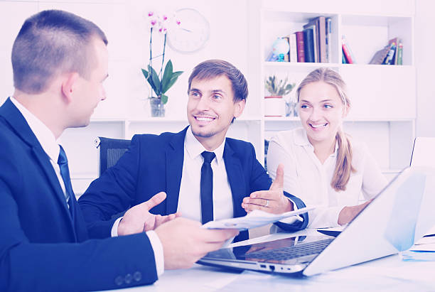 istock Coworkers chatting about business project 637602508