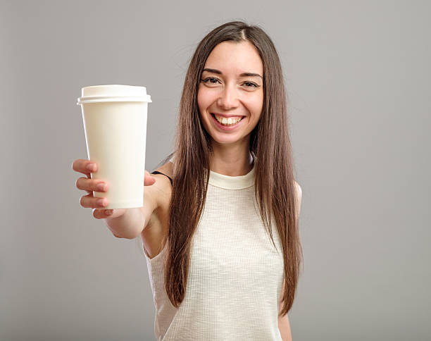 istock Woman offering white cup of coffee 637602776