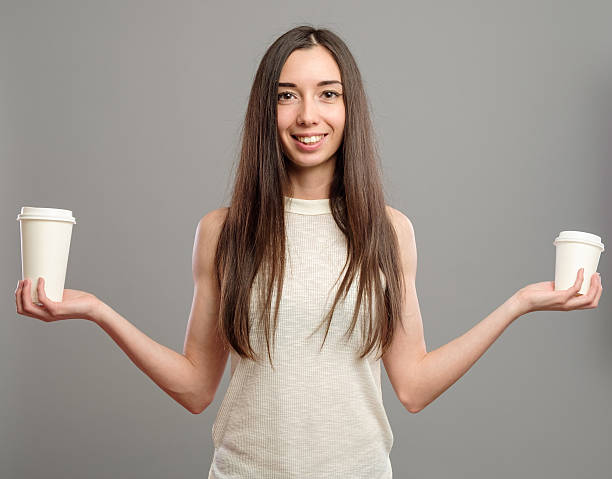 istock Woman offering white cups of coffee 637602820