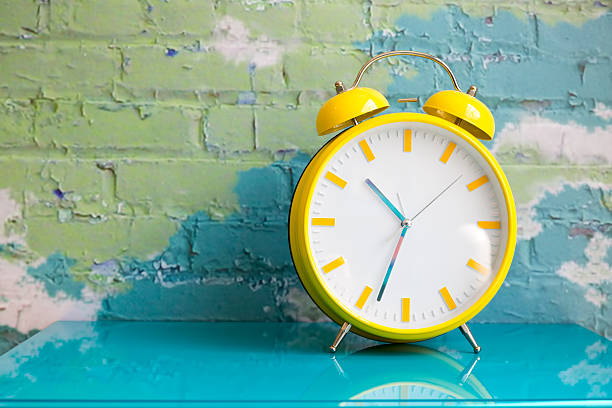 istock Big yellow retro style alarm clock 637603056