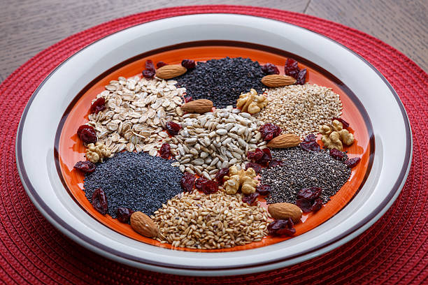 assortment of fresh dried seeds used as ingredients in cooking. - quinoa sesame chia flax seed imagens e fotografias de stock