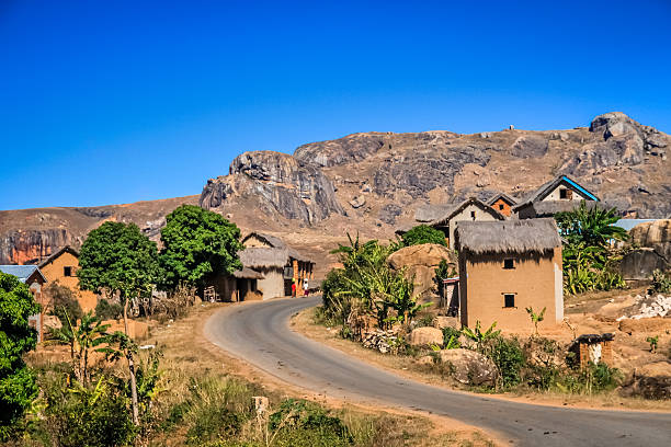 istock Road through malagasy village 637605252