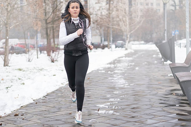 istock Young woman running in a winter day. 637606774