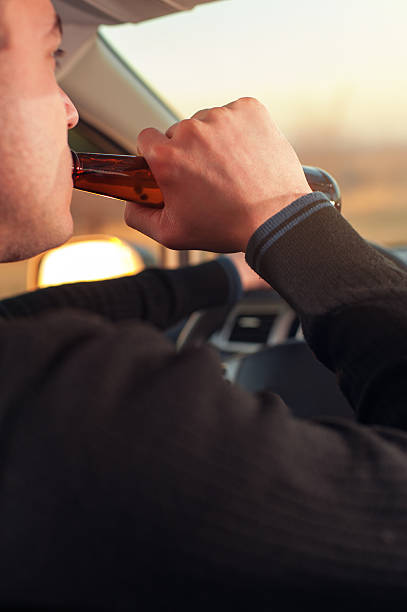 istock Young man drinking alcohol and driving a car 637608144