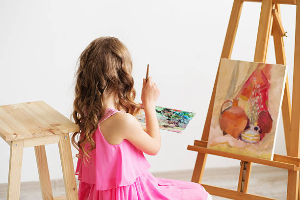 lovely little girl painting a picture in a studio - drinking little girls women wine imagens e fotografias de stock