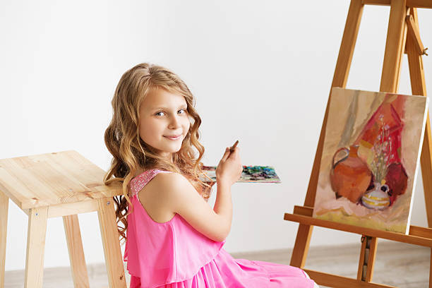 lovely little girl painting a picture in a studio - drinking little girls women wine imagens e fotografias de stock