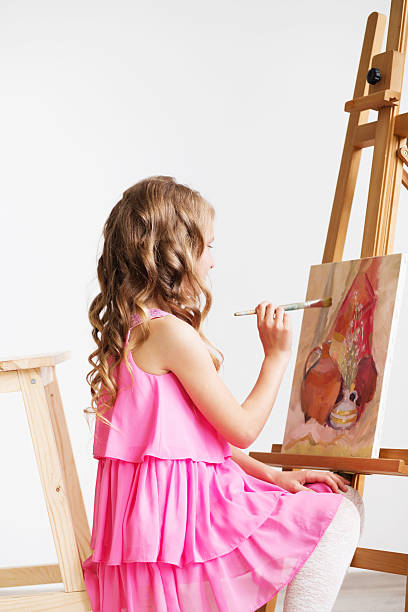 lovely little girl painting a picture in a studio - drinking little girls women wine imagens e fotografias de stock