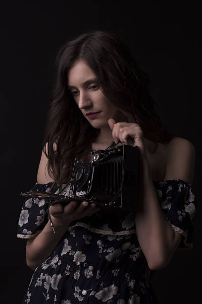 istock Pretty young model photographer with old camera 637609852