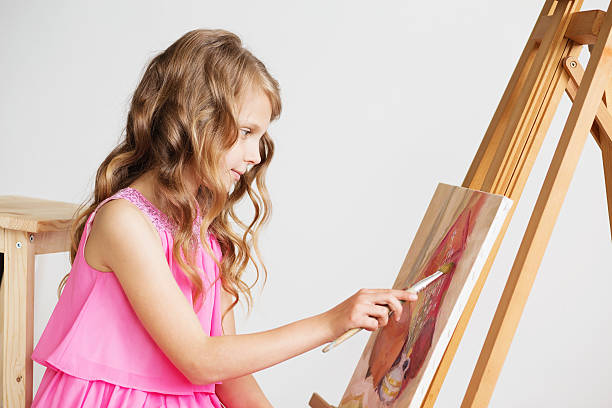 lovely little girl painting a picture in a studio - drinking little girls women wine imagens e fotografias de stock