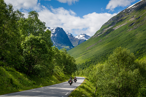 Empty road with mountain peaks on the horizon. Norwegian national travel route. Road to Trollstigen, Norway.