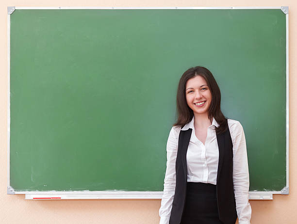 istock Student girl standing near clean blackboard 637613876