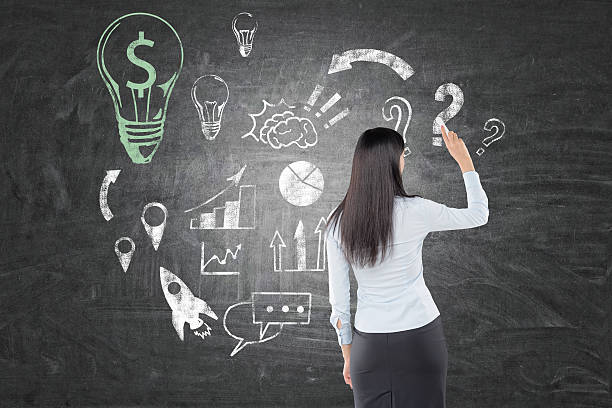 istock Woman with black hair is drawing dollar light bulb 637614272