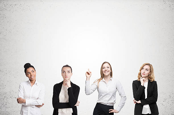 istock Four women brainstorm near concrete wall 637614862