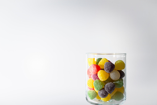 a glass of sweets on a white background