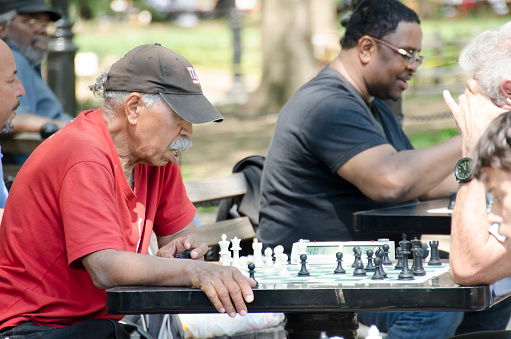 New York City, United States - May 4, 2015: old man playing chess in Washington square Park in Manhattan