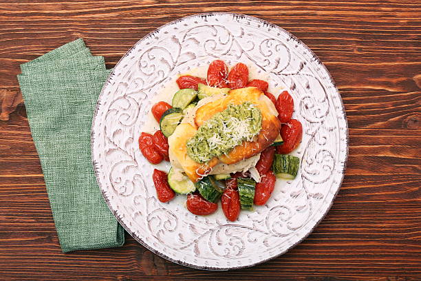istock Baked chicken breasts which basil pesto sauce, tomatoes, and che 637616990