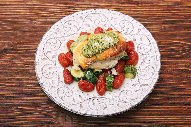 istock Baked chicken breasts which basil pesto sauce, tomatoes, and che 637617030