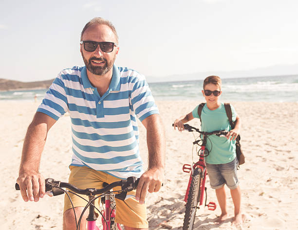 istock Father and his son with bicycle 637617442