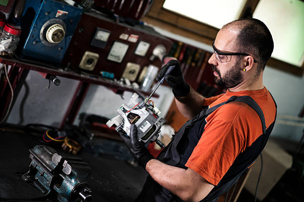 istock Manual worker repairing electric motor in a workshop. 637619000