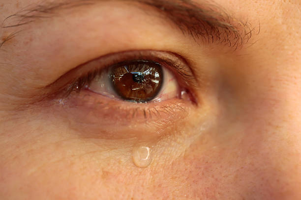 istock Close up of eye with tears. Tear drop 637620208
